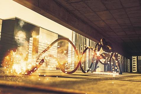 Sportler beim Training mit einem Fitnessseil auf einem modernen, urbanen Gelände, dabei entstehen Funken und Bewegung.